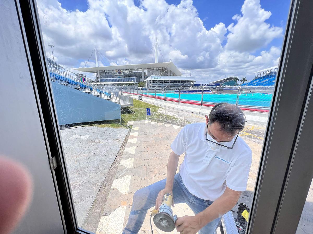 Glass restoration specialist polishing a window by hand